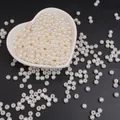 Perle d'imitazione in ABS bianco lucido per braccialetti fai-da-te in una ciotola a cuore - Perline rotonde / 5mm (200 Pezzi/Confezione) / Beige