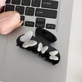 Elegant black hair claw clip featuring three pearl-like butterflies and inlaid rhinestones - Black 3D Butterflies