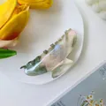 Close-up of marble acetate hair claw clip styled with tulip and fashion magazine - Large / Ink Green
