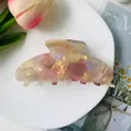 Macro detail of large iridescent pink acetate hair claw clip with shell texture pattern - Orange Iridescent 10cm