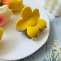 Detailed view of yellow flower hair claw clip on a white plate with floral background - Yellow Grey Color Block