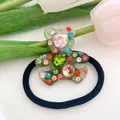 Close-up of a translucent resin bear hair tie with colorful crystals and rhinestones - 1-Translucent Gray