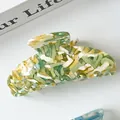Detail of large acetate hair claw clip showing green and white marble texture - Yellow-Green