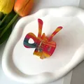 Detail view of the colorful butterfly hair claw clip with rainbow acetate patterns - 6.5*5cm / Colorful