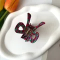 Detailed view of colorful acetate butterfly hair claw clip with golden metal spring - 6.5*5cm / Red and Green
