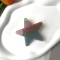 Macro detail of a glittery gradient star hair clip on a white ceramic tray with tulips - Glitter Multi