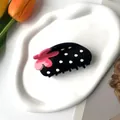 Close-up of black hair claw clip with white dots and a decorative pink flower - Large / Black Strawberry
