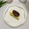 Detailed view of creative snail-shaped acetate hair claw with yellow and tortoiseshell patterns - Snail