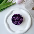 Detailed top view of purple marble-textured scalp massage brush on white ceramic tray - Dark Purple