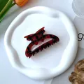 Red and black checkered bow claw clip on a ceramic tray with floral background - Bow Claw Clip