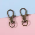 Zwei antike bronzene Karabinerverschlüsse aus Metall mit 360 Grad drehbaren Haken - 13x34mm (20 Stück/Packung) / Antike Bronze