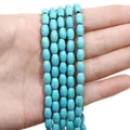 Strands of oval turquoise beads with natural brown mesh patterns held in hand - Oval Bead / 5x8mm (Approx. 48 Pcs) / Sky Blue