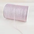 Macro detail of pink glitter elastic ribbon roll for DIY crafts and gift wrapping - Pink