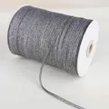 Macro detail of metallic silver glitter ribbon on roll for gift wrapping and DIY crafts - Dark Gray