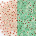 DIY acrylic heart beads showing white daylight and green luminous glow effects - Luminous White Red Heart Flat Bead