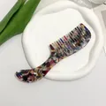 Top view of acetate hair comb with marble pattern on a white ceramic tray - Floral Pattern