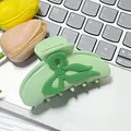 Elegant light green bow claw clip with glossy finish for a chic summer hairstyle - Green