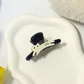 Mini black claw clip featuring a cute cream cat decoration on a ceramic tray - Running Cat