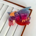 Detail of creative pterodactyl hair claw clip with colorful marble resin texture - Pterosaur