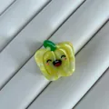 Close-up of a cute yellow bell pepper hair claw clip with a smiling face expression - Yellow Pepper Shape