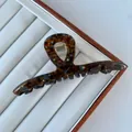 Close-up of tortoise shell acetate hair claw clip with colorful rhinestones details - Crossed / 11.5x4.5cm / Blue Brown Tortoiseshell