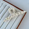 Close-up of cream acetate hair claw clip decorated with vibrant multi-color rhinestones - Crossed / 11.5x4.5cm / Off White
