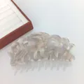 Macro detail of 14cm acetate crown claw clip showing marble texture and wavy edges - Large / Shiny Grey