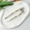 Detail of marble pattern acetate U-shaped hair fork with bow on ceramic tray - Gray