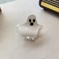 Detailed view of a white ghost-shaped acrylic hair claw clip for Halloween fashion - Hugging Ghost Style