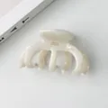 Detailed view of cream acetate hair claw with gold lettering and non-slip teeth - 9.5*5.5cm, 36g / Pearl White