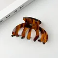Close-up of tortoise shell pattern acetate hair claw with gold logo and anti-slip teeth - 9.5*5.5cm, 36g / Brown