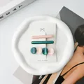 Detailed set of acetate hair clips in pink and green displayed on a marble tray - Pink And Teal
