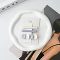Detailed view of purple and beige acetate hair clips set on a stylish display card - Light Blue & White