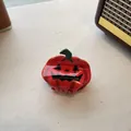 Halloween pumpkin hair claw clip with Jack-o'-lantern face and glossy orange finish - Small Pumpkin Style