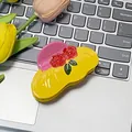 Pink and yellow acetate hat hair claw with red roses on a laptop keyboard - Yellow Hat