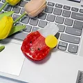 Red apple shaped acetate hair claw clip with smiling face design on laptop - Ping Pong Racket