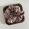 Close-up of French style satin hair scrunchie in dusty rose on a wooden tray decor - Medium / Korean Pink