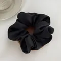 Close-up of black satin hair scrunchie with smooth silk texture on white background - L / Black