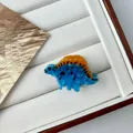 Mini dinosaur hair claw in lake blue acetate with orange spines and Y2K aesthetic - Mini Blue Dinosaur