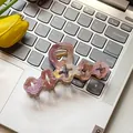 Pink and purple acetate floral hair claw clip on silver laptop keyboard background - Peach Blossom Pink