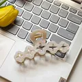 Elegant cream clover hair claw clip with pearlescent finish on a laptop keyboard - Hollow Flower / 10cm / Mermaid White