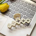 Elegant cream clover hair claw clip placed on a keyboard with a yellow tulip accent - Hollow Flower / 10cm / Milk White