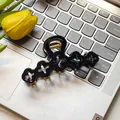 Elegant black hollow floral hair claw clip with golden spring on a laptop background - Hollow Flower / 10cm / Black