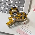 Elegant tortoiseshell heart-shaped hair claw clip with golden metal teeth on a laptop - Dark Tortoiseshell (5cm*6.5cm)