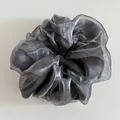 Detail of silver grey organza hair scrunchie with shimmering texture and soft pleats - Gray