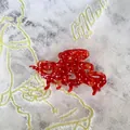 Macro detail of octopus-shaped acetate hair claw featuring red finish and white polka dots - Polka Dot Octopus Shape (E)