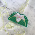 Detail of green acetate hair claw with a pearlescent white lily and golden accents - Lily Flower Shape (G)
