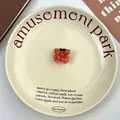 Close-up of a cute orange acetate crab hair claw clip on an elegant ceramic plate - Orange Crab Style (E)