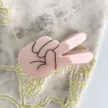Pince à cheveux en acétate rose en forme de main de dessin animé sur tissu gris - Geste De Dessin Animé Rose