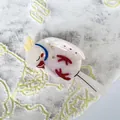 Macro detail of bird-shaped hair claw clip with pearlescent finish and star patterns - 14.5*7.5cm / Mermaid White
